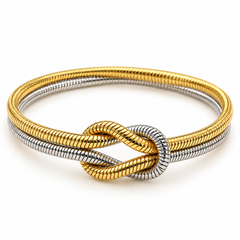A double-strand snake-coil style bangle bracelet featuring a twisted knot design, combining polished yellow gold and silver-tone metal, set against a clean white background.