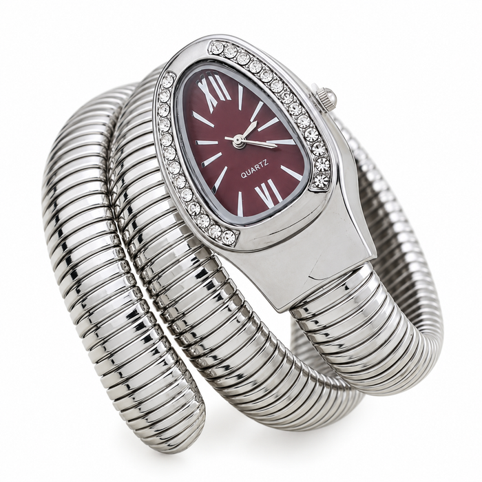 A silver-tone wrap bracelet watch with a coiled snake-style band, a bezel set with small clear crystals, and a dark burgundy dial with Roman numerals.