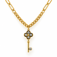 A gold chain necklace featuring a key-shaped pendant with a four-petal flower design set with clear round stones, photographed on a clean white background.
