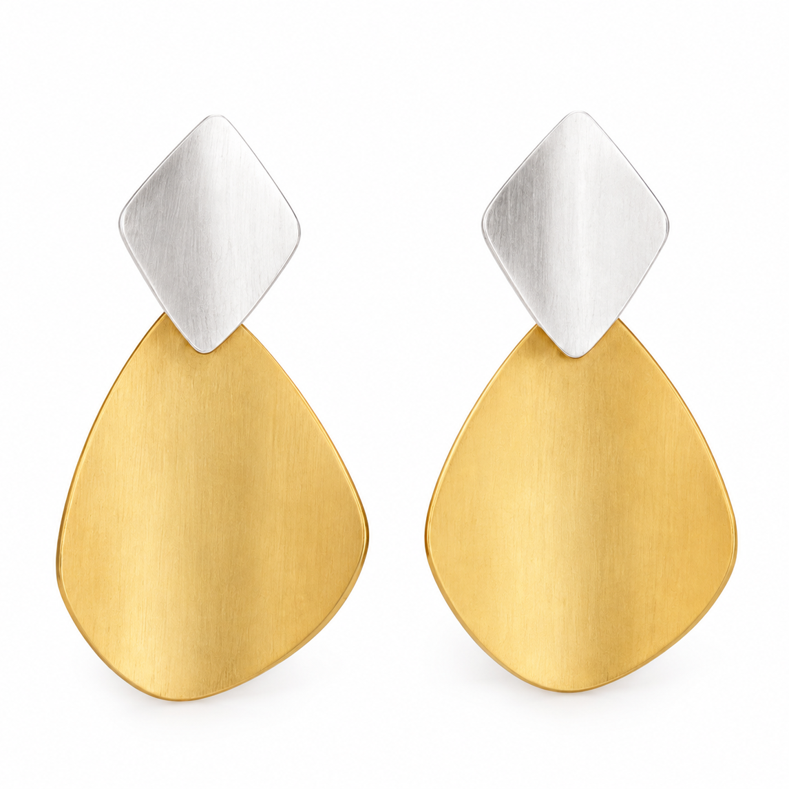 A pair of modern dangle earrings featuring a brushed silver diamond-shaped stud on top of a brushed gold teardrop-shaped drop, shown against a plain white background.