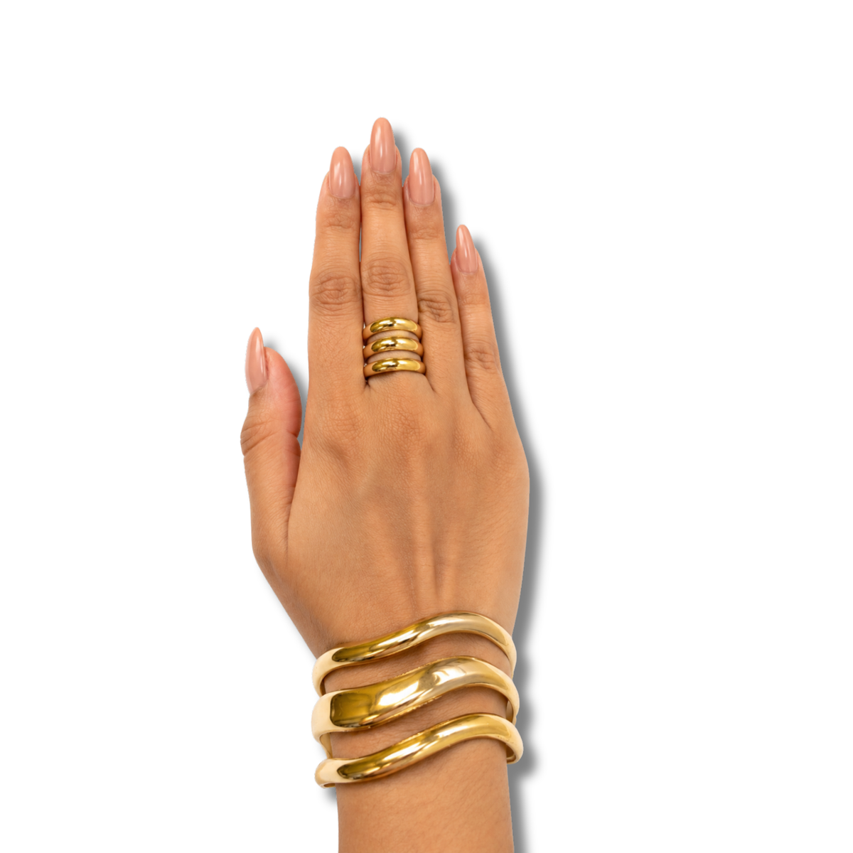 A hand with manicured nails wearing a stack of four gold rings on the middle finger and a matching multi-band gold bracelet on the wrist, set against a plain white background.