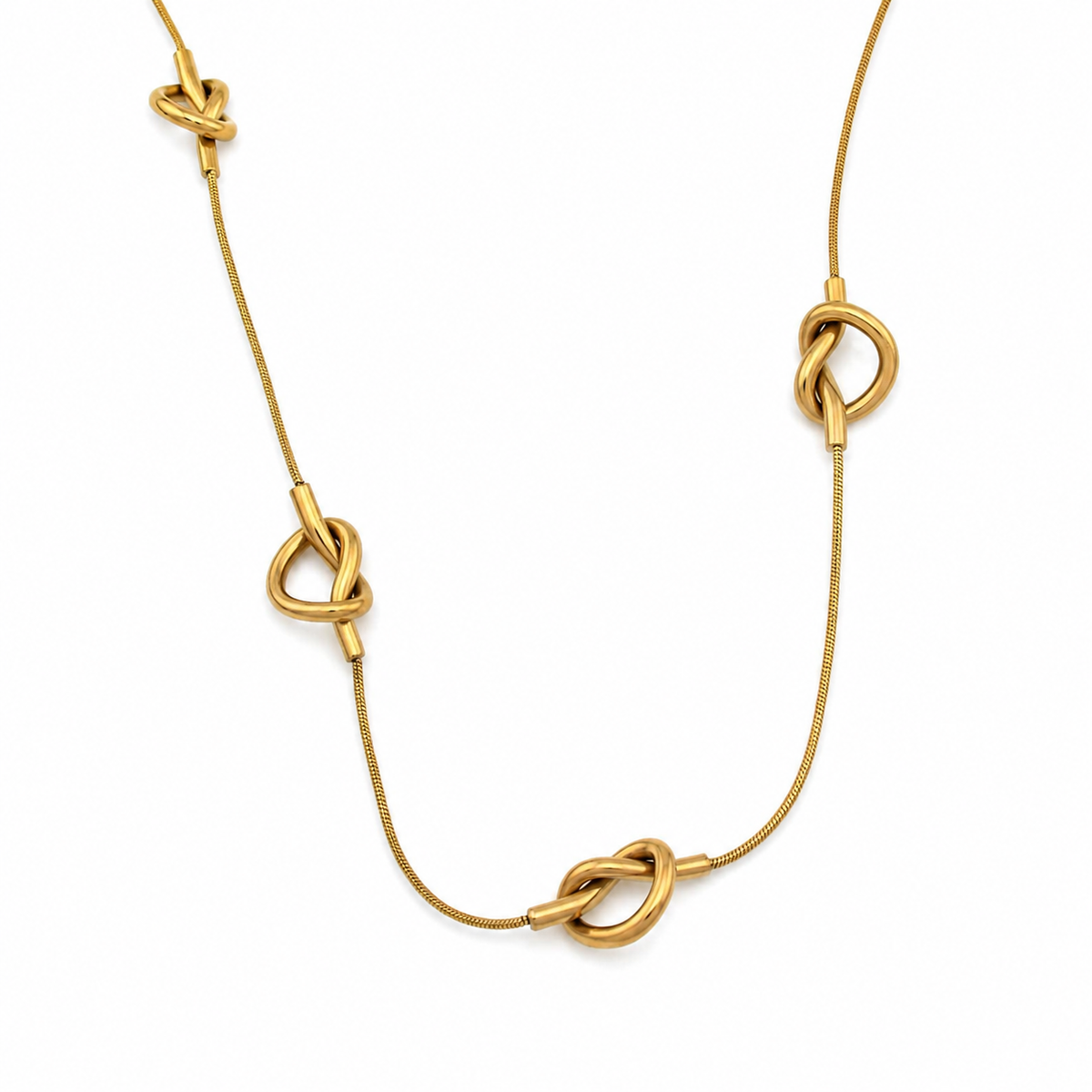 A gold necklace featuring four knotted decorative elements spaced along a fine chain, displayed on a clean white background.