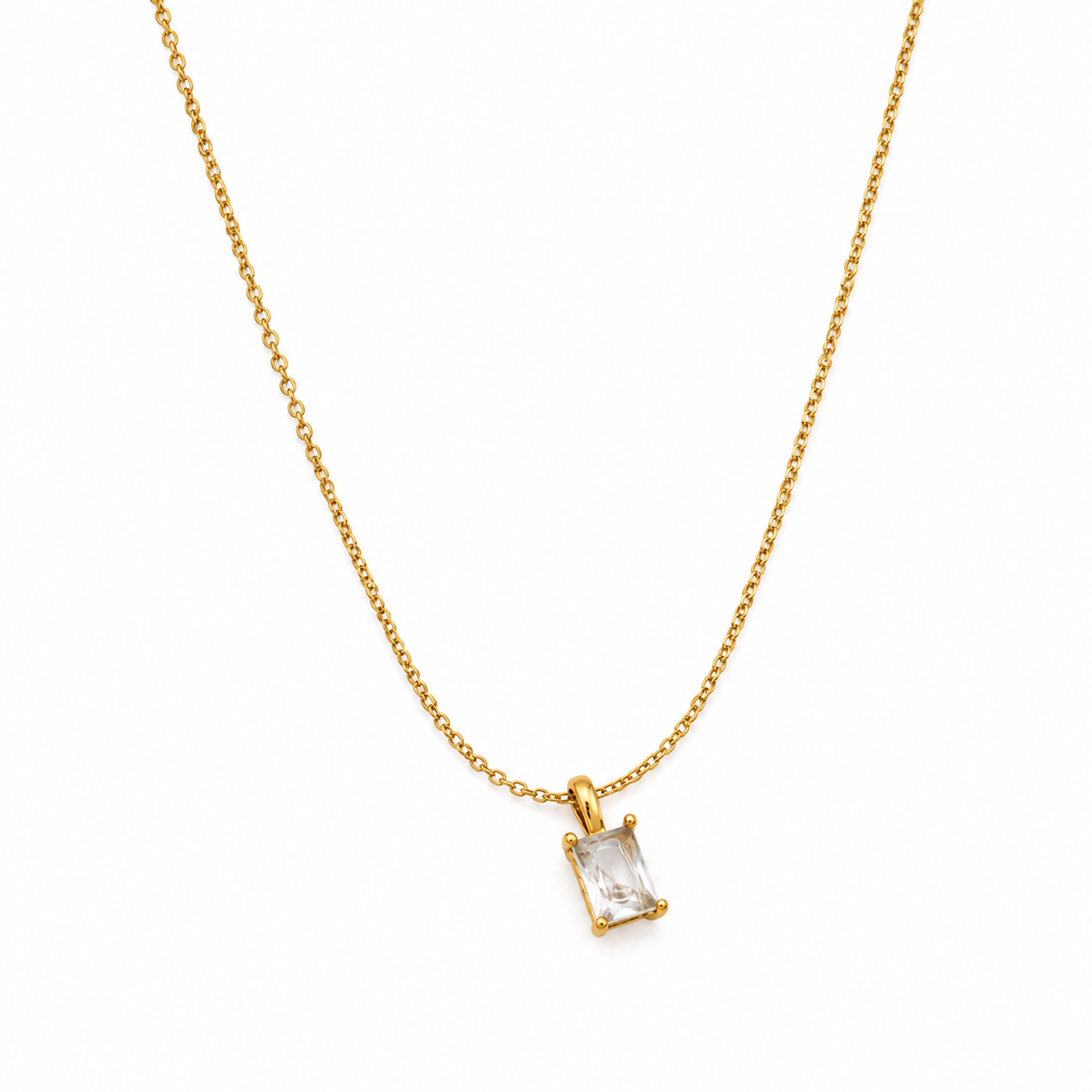 A delicate gold chain necklace with a small rectangular clear gemstone pendant in a gold bezel setting, shown against a plain white background.
