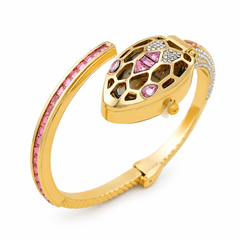 Gold snake head bangle bracelet with pink and clear stones, shown on a white background.