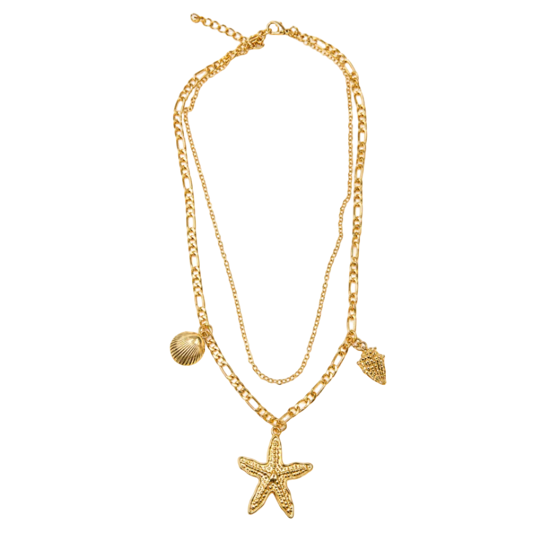 A gold-toned double-layered necklace featuring a textured starfish pendant, a small seashell charm, and a smaller conical shell charm, displayed on a clean white background.