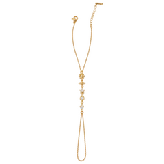 A delicate gold chain anklet featuring a vertical line of small gold charms and clear rhinestone accents, displayed on a solid white background.