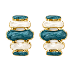 A pair of gold-plated earrings featuring stacked organic-shaped inlays of teal blue enamel and white mother-of-pearl.