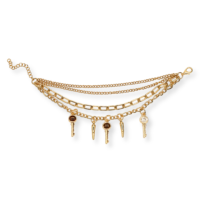 A gold-toned multi-strand chain necklace featuring five dangling key charms, one with a dark brown center and one with a clear rhinestone, displayed on a clean white background.