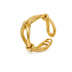 A polished gold-toned ring with an open, twisted, and looped design, photographed on a clean white background.