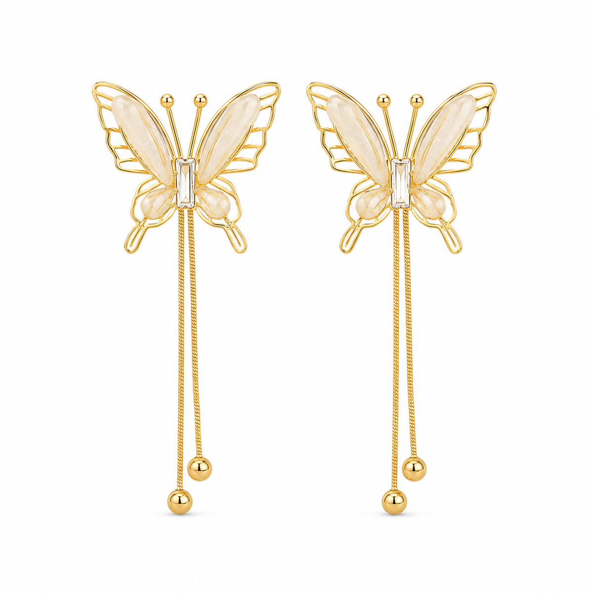 A pair of gold butterfly drop earrings with iridescent cream wings and a small clear crystal at the center, hanging from double dangling chains with gold beads.