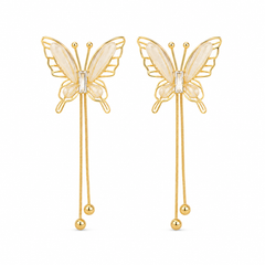 A pair of gold butterfly drop earrings with iridescent cream wings and a small clear crystal at the center, hanging from double dangling chains with gold beads.