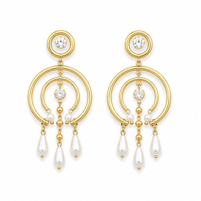 A pair of gold dangle earrings with white pearl teardrop drops and clear round gemstones, shown on a plain white background.