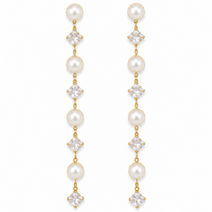 A pair of gold drop earrings featuring white pearls and clear square-cut crystals, arranged vertically on a plain white background.