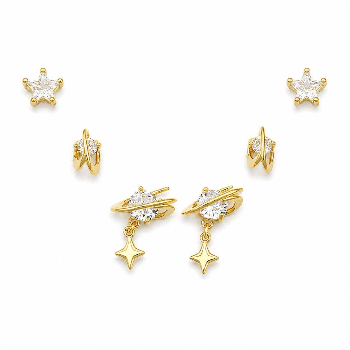 A set of gold-toned celestial stud earrings with clear cubic zirconia stones, including starburst, crescent moon, and double-ring designs, arranged on a clean white background.