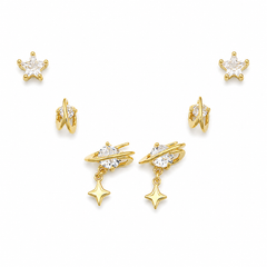 A set of gold-toned celestial stud earrings with clear cubic zirconia stones, including starburst, crescent moon, and double-ring designs, arranged on a clean white background.