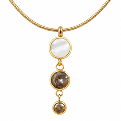 A gold snake chain necklace featuring a vertical dangle pendant with three round bezel-set stones: a large white mother-of-pearl disc at the top, and two smoky brown gemstone discs below, set against a plain white background.
