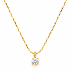 A yellow gold necklace with a single round-cut diamond pendant and small accent diamonds on the bail, shown against a plain white background.