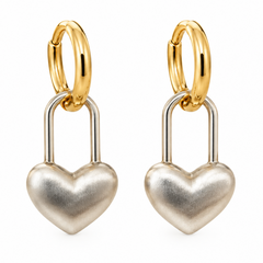 A pair of gold and silver heart-shaped hoop earrings on a plain white background.
