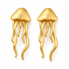 A pair of gold jellyfish-shaped earrings with wavy tentacles, displayed on a clean white background.