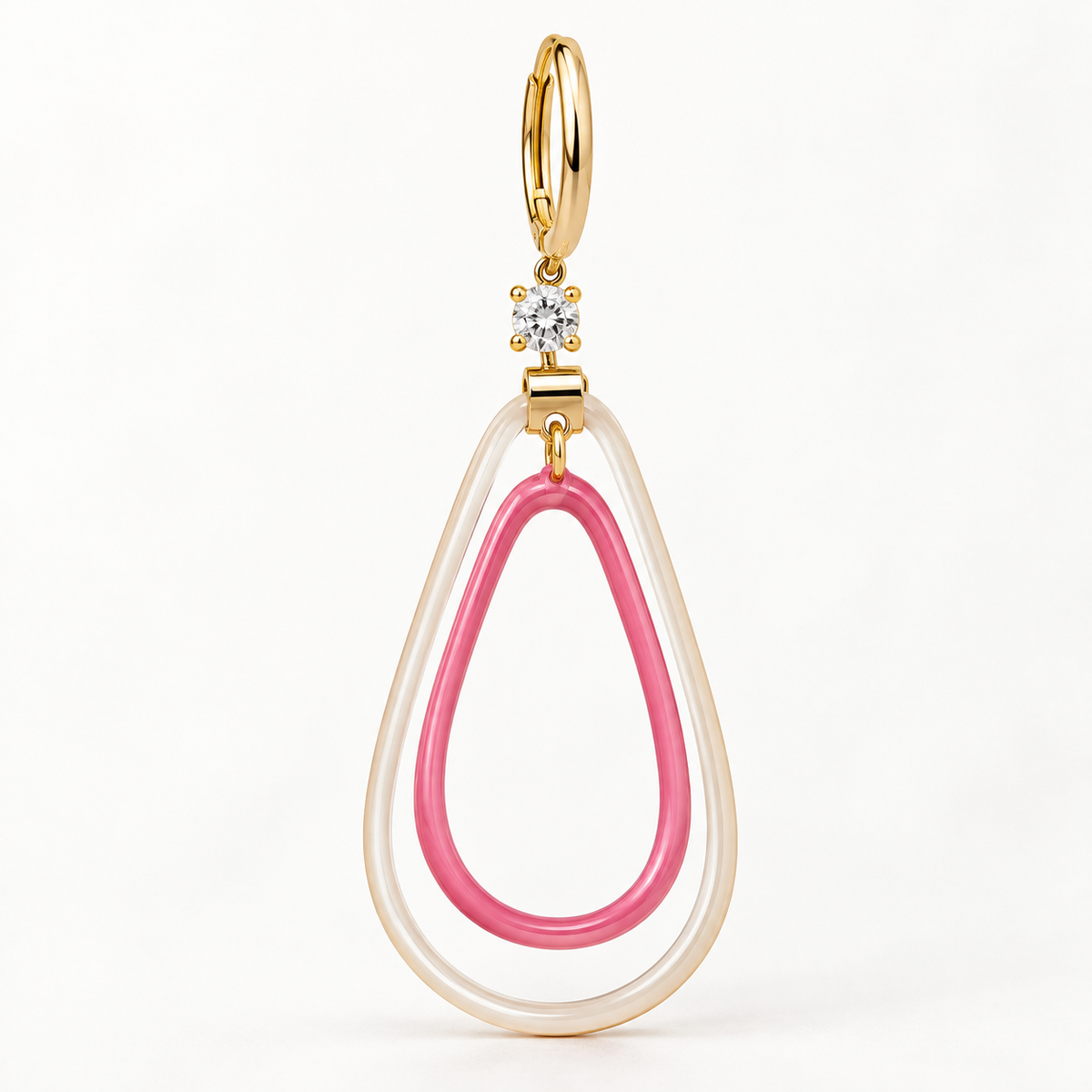 A gold-tone teardrop-shaped pendant earring featuring a translucent white outer ring, a pink inner ring, and a small clear crystal accent at the top.
