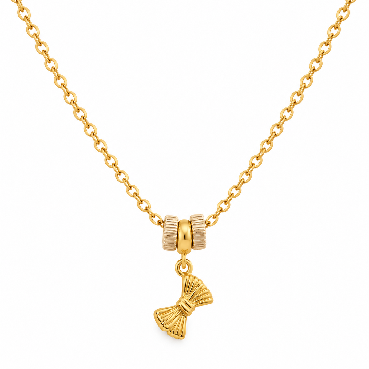 A gold chain necklace featuring a decorative charm with two textured gold beads and a dangling gold bow-shaped pendant, shown against a plain white background.
