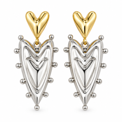 A pair of dangling earrings with polished yellow gold heart-shaped studs and silver-toned teardrop charms outlined with small metallic beads, shown on a plain white background.